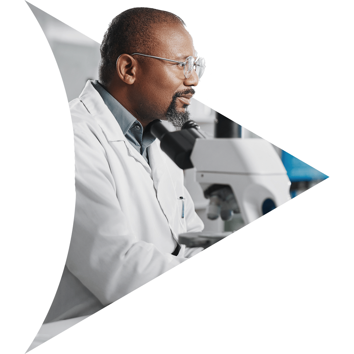Man wearing glasses looking through a microscope