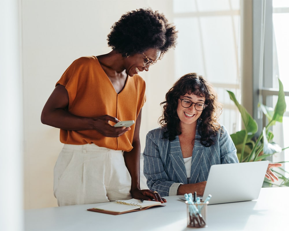 Two women looking at a laptop